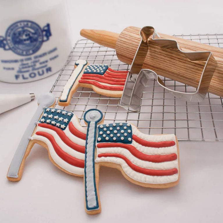 American Flag cookies on a counter with baking supplies